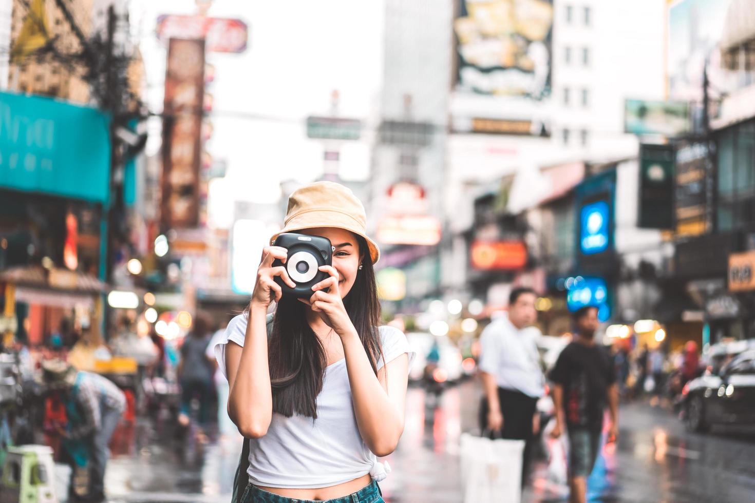 asiatische reisende frau mit kamera in chinatown. foto