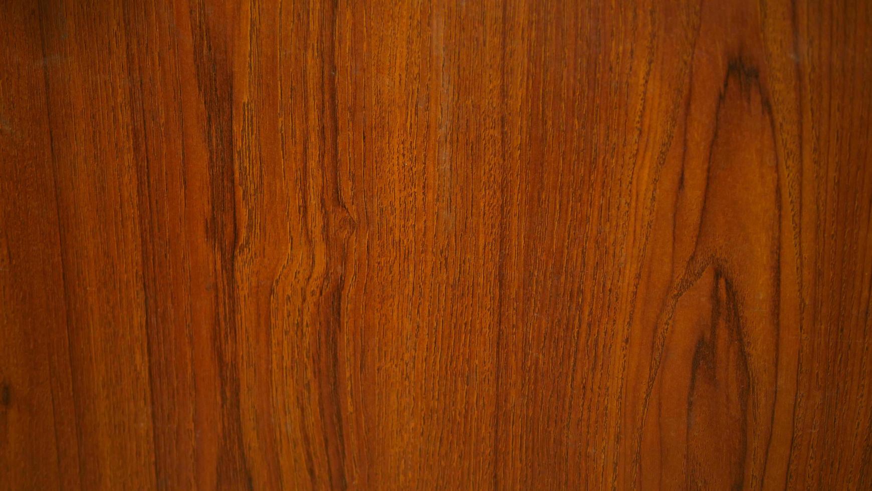 Holzmaserung für die Herstellung von Hintergrund oder Tapete. Holzmaserung, Rot- und Schwarzton. rotes Teakholzmuster. foto