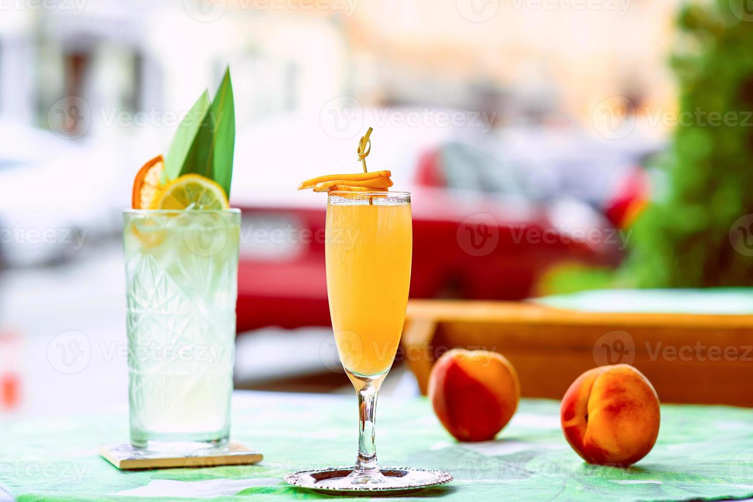 Limonade und Bellini-Cocktail stehen auf dem Tisch auf der Terrasse der Bar im Freien in der Innenstadt foto