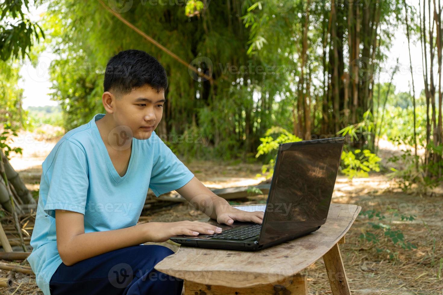 Ein Junge konzentriert sich auf das Online-Lernen mit einem Laptop-Computer zu Hause auf dem Land foto