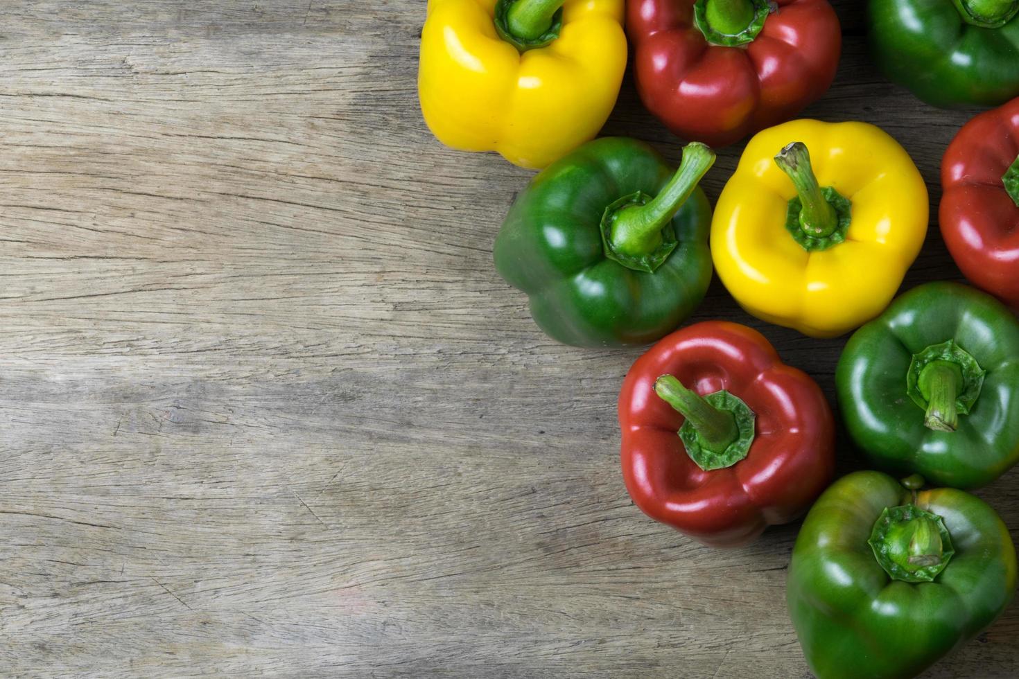 farbige Paprika auf Holztisch foto