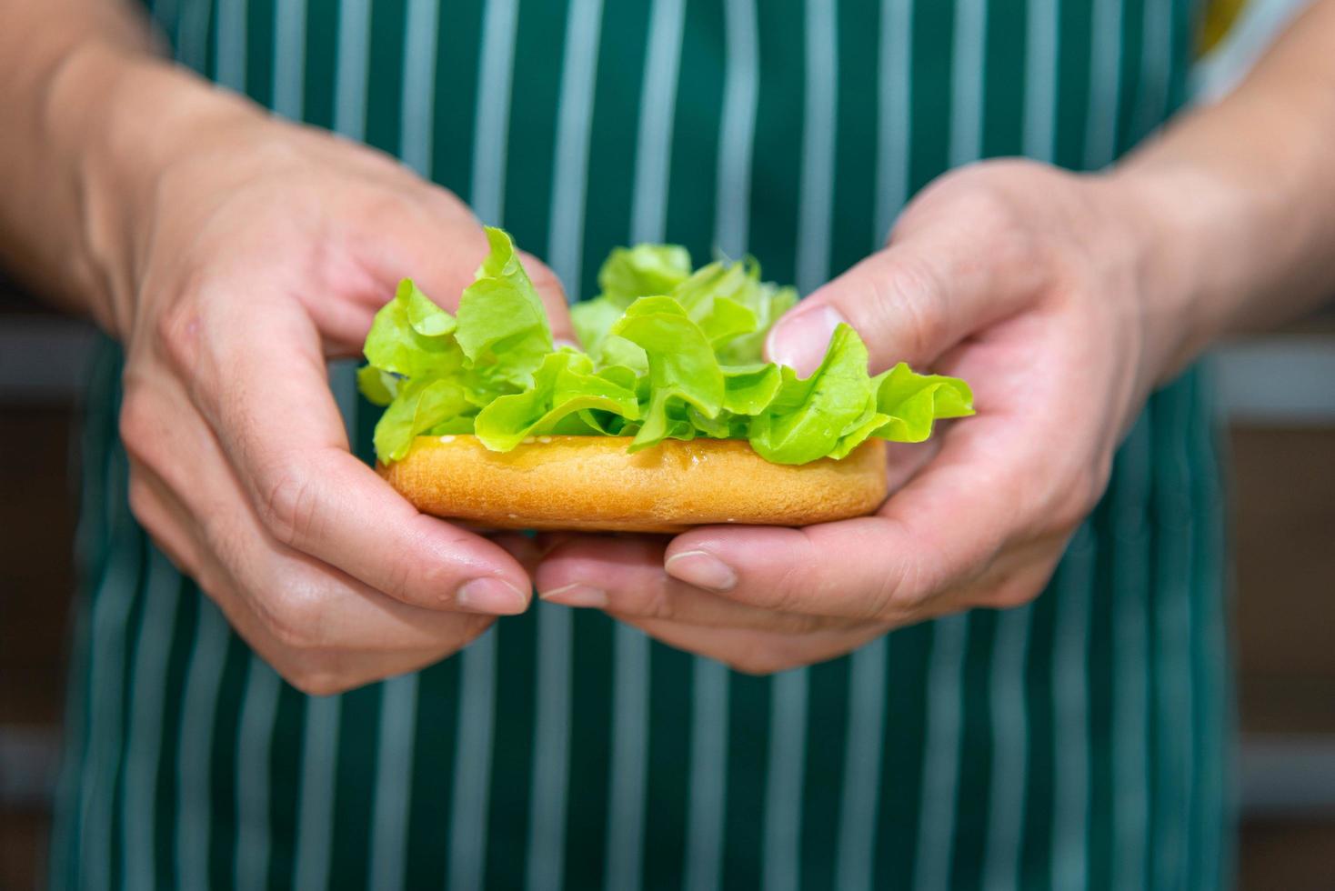 Küchenchef bereitet Brotzwiebel-Tomatengemüse zu und macht Hamburger in der Küche. foto