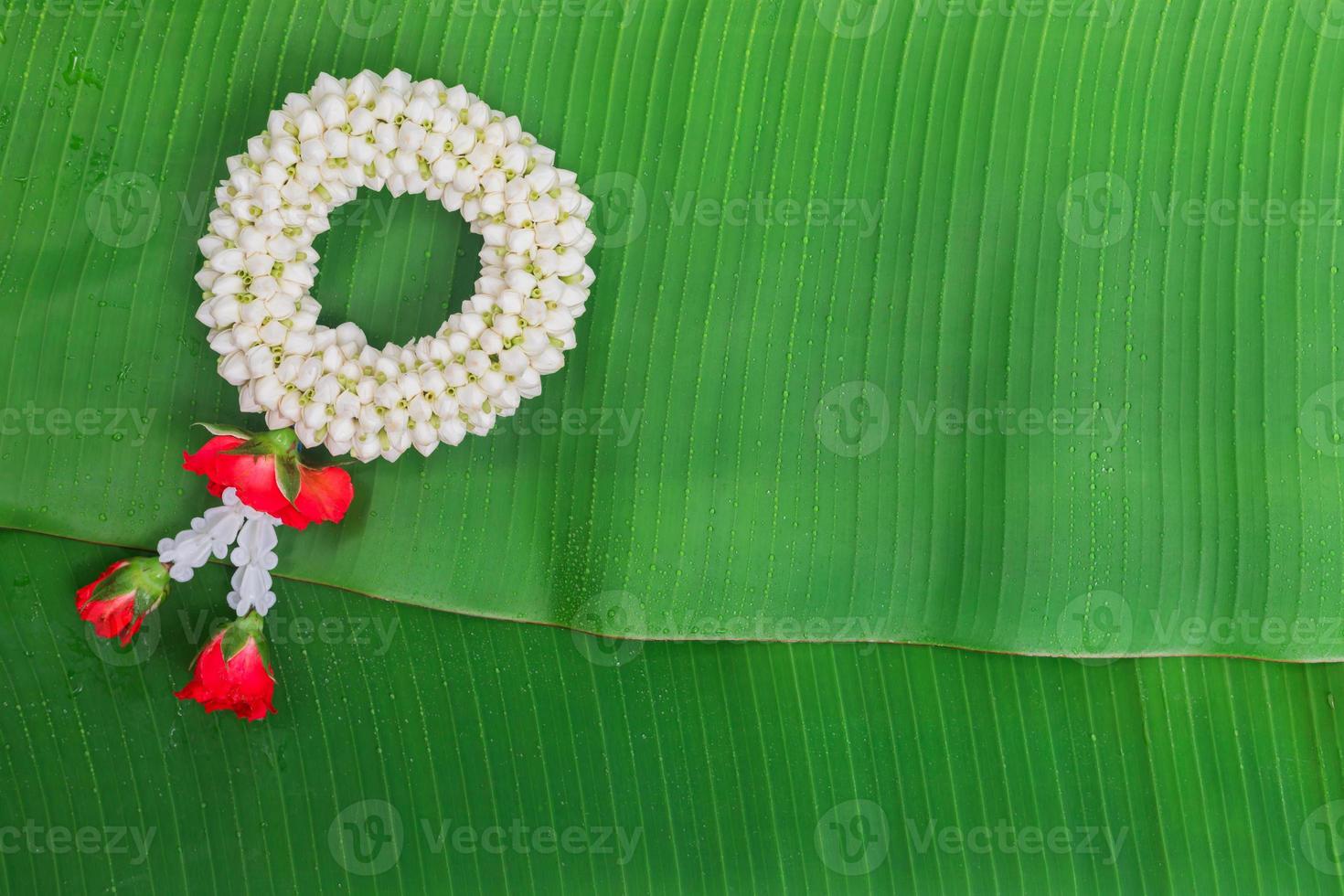 songkran festival hintergrund mit jasmingirlande auf grünem bananenblatthintergrund foto