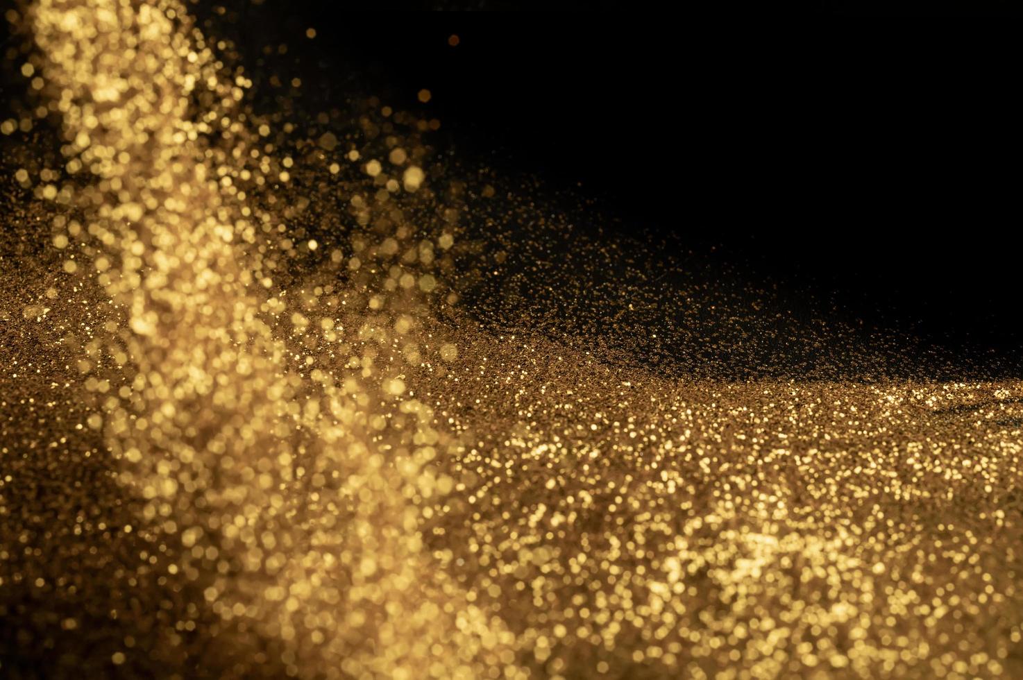 Goldpartikelstaub für den Hintergrund foto