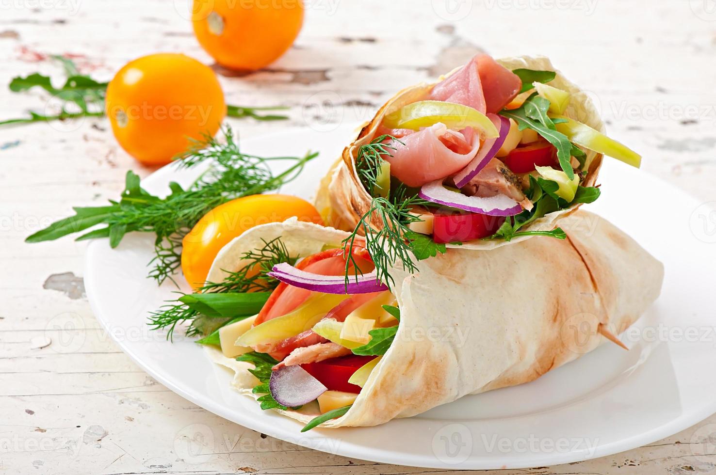 frische Tortilla Wraps mit Fleisch und Gemüse auf Teller foto