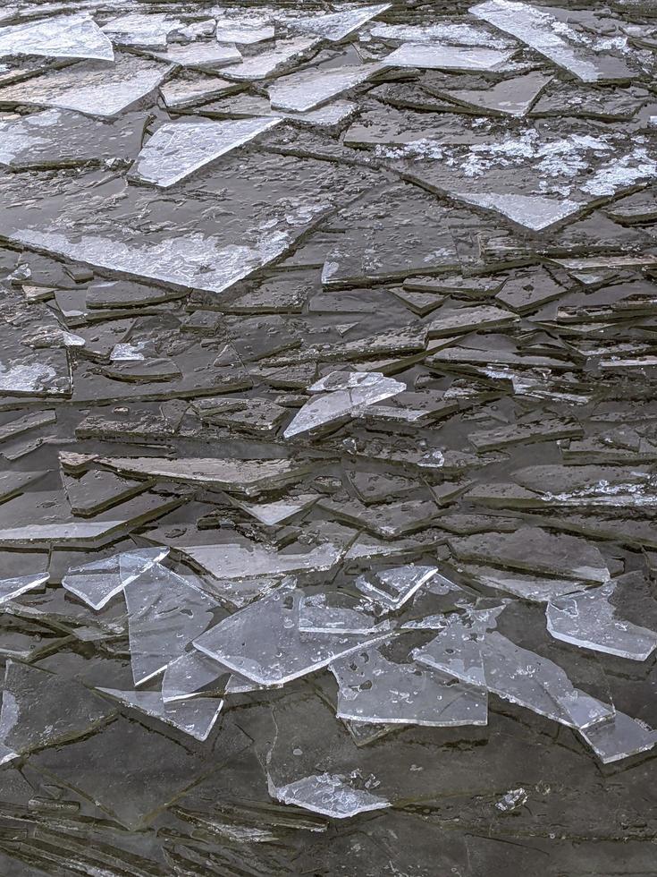 zerschmetterte Eisstücke auf der Wasseroberfläche. strukturierter hintergrund nahaufnahme. foto