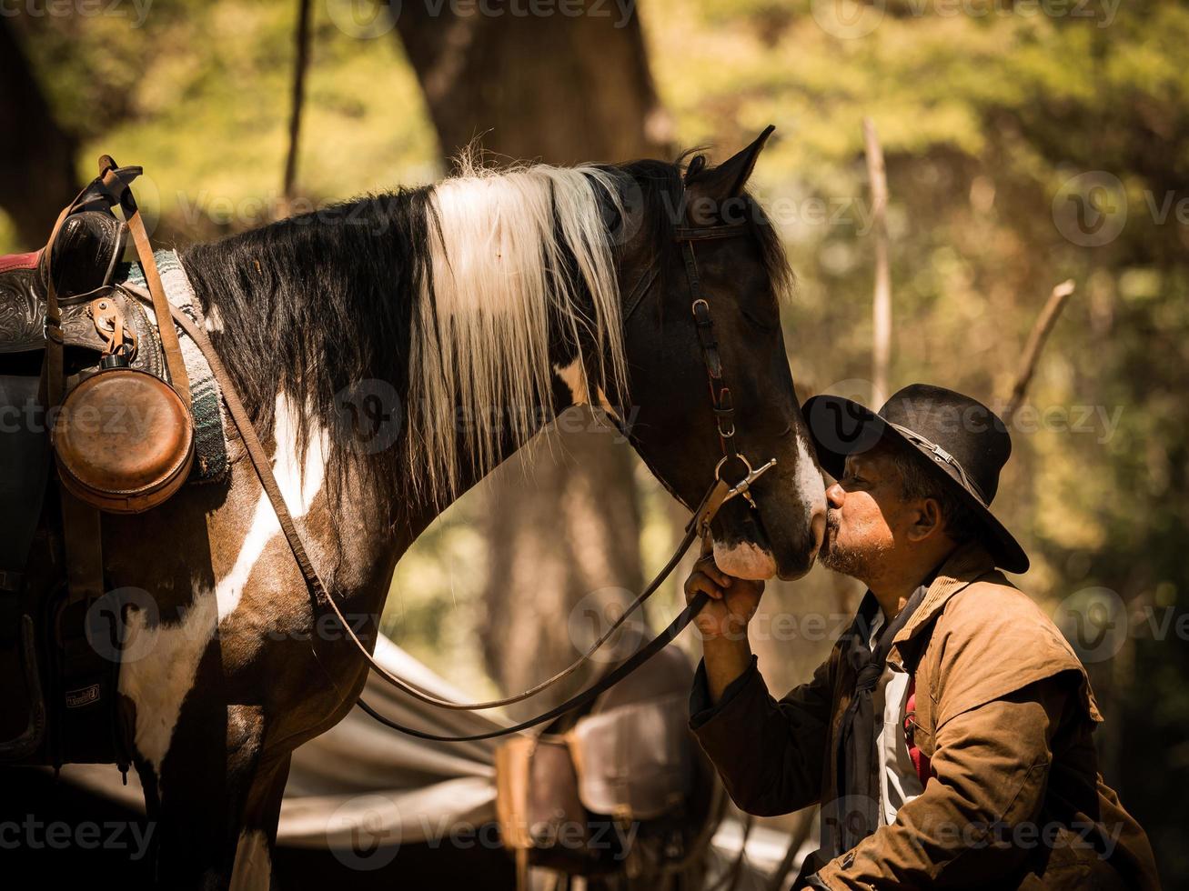 Cowboy küsst das Pferd mit Liebe foto