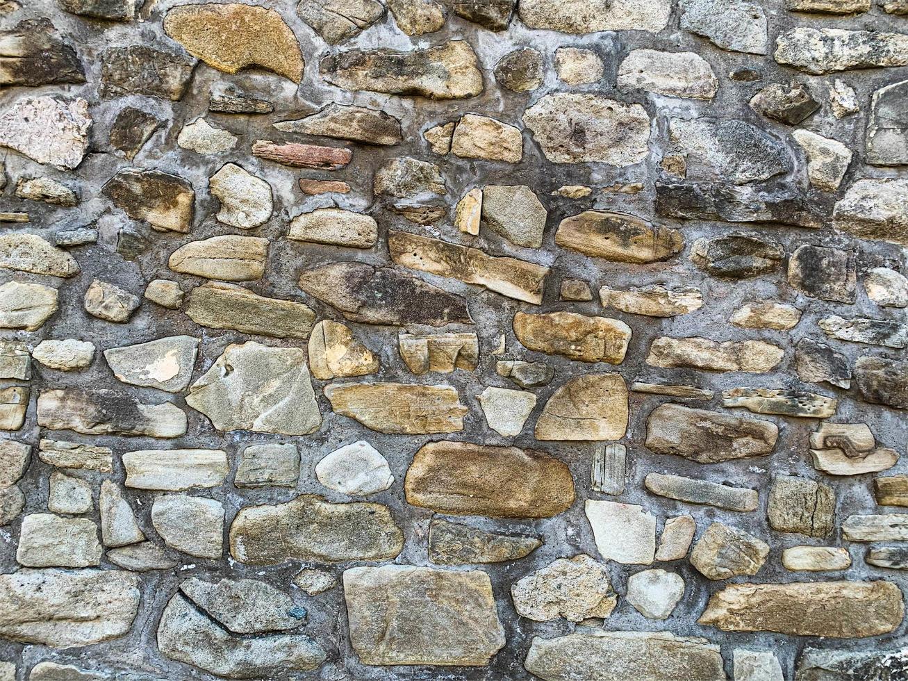 Hintergrund der alten Steinmauer. steinerne Kulisse foto