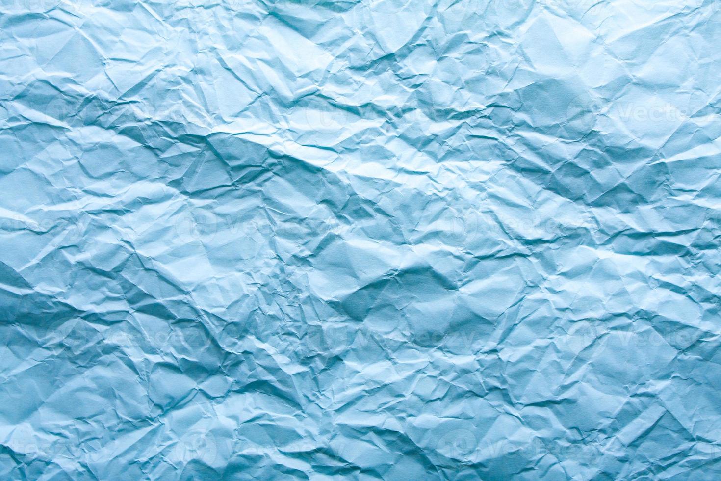blauer zerknitterter Papierhintergrund mit abstraktem nahtlosem Muster. zerknitterte papierstruktur. foto