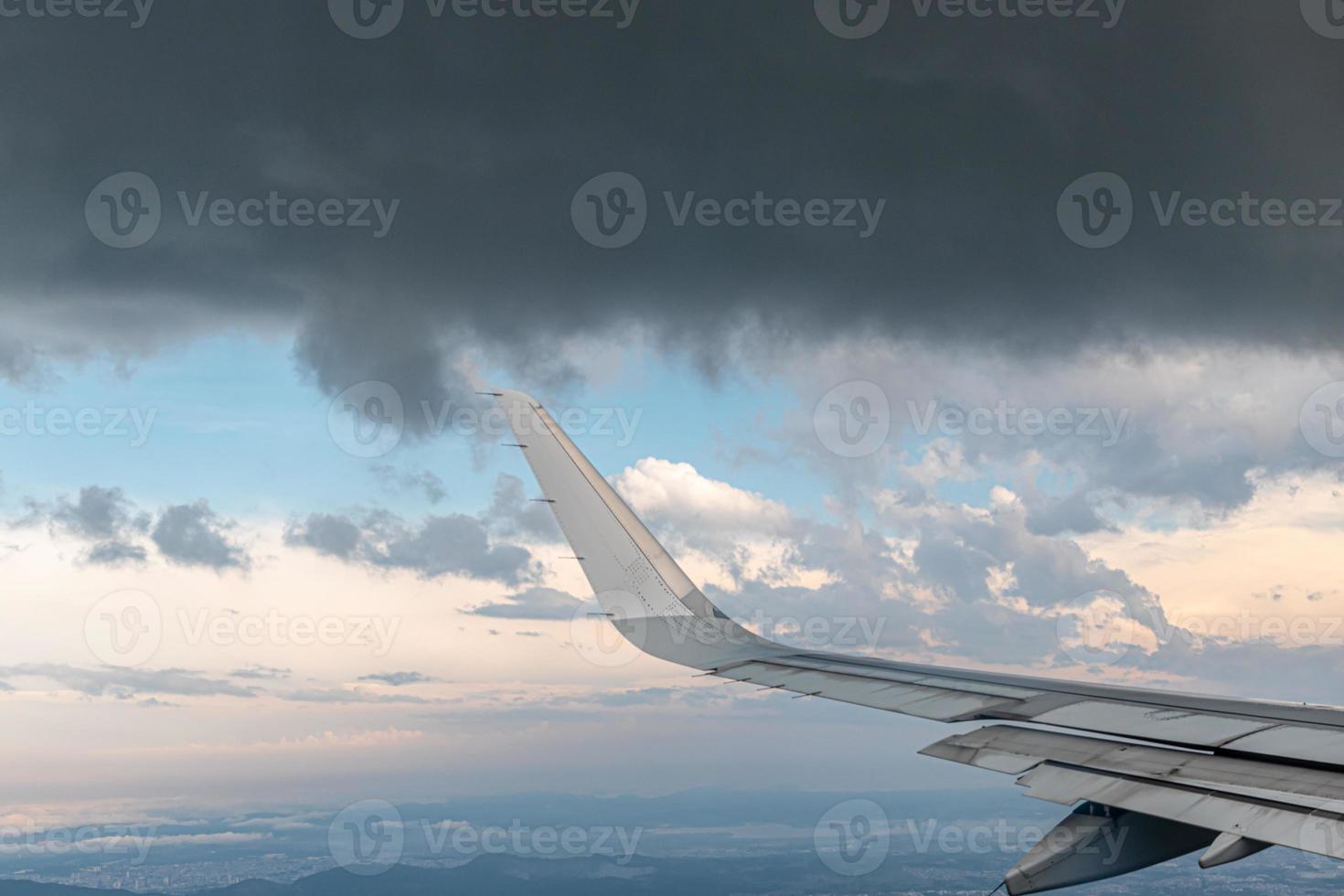 Flugzeug, das in der Nähe von Gewitterwolken vorbeifährt foto