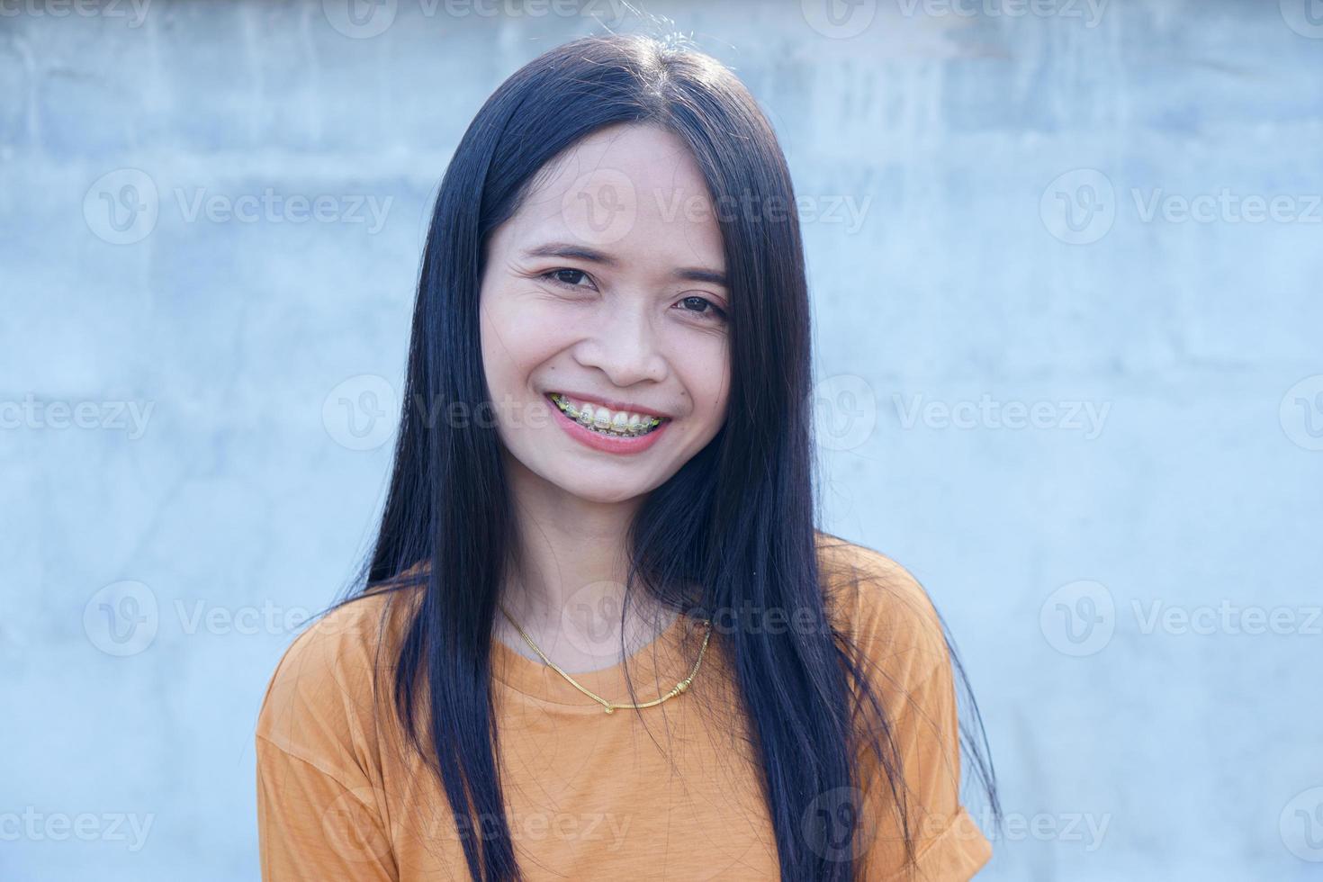 asiatische frau, die einen hut trägt, der glücklich lächelt foto