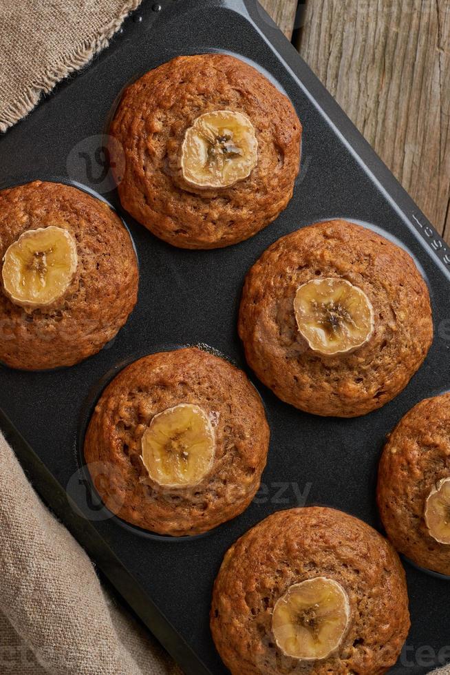 bananenmuffin im fach, draufsicht, kopierraum. Muffins auf alten Leinenservietten, foto