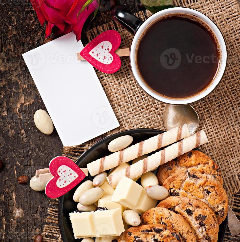 Tasse Kaffee mit weißer Schokolade, Mandeln und Keksen foto