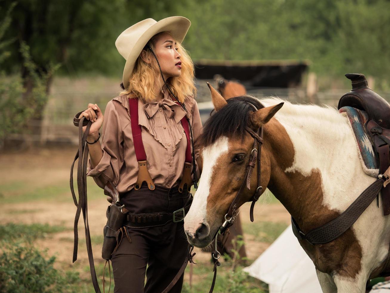 Cowgirl und das Pferd sind aufgrund ihrer zerrütteten Beziehung in einem wilden Gesetzlosen tief in der Liebe miteinander verbunden foto