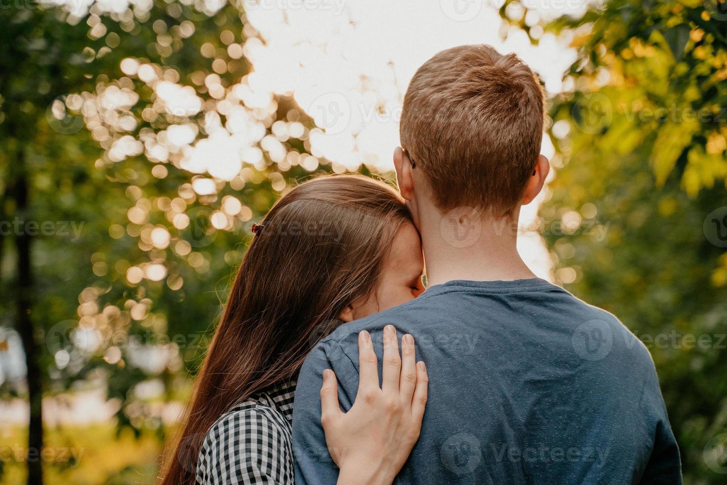 Mädchen legte ihren Kopf auf seine Schulter, Liebe im Park, Teenie-Paar foto