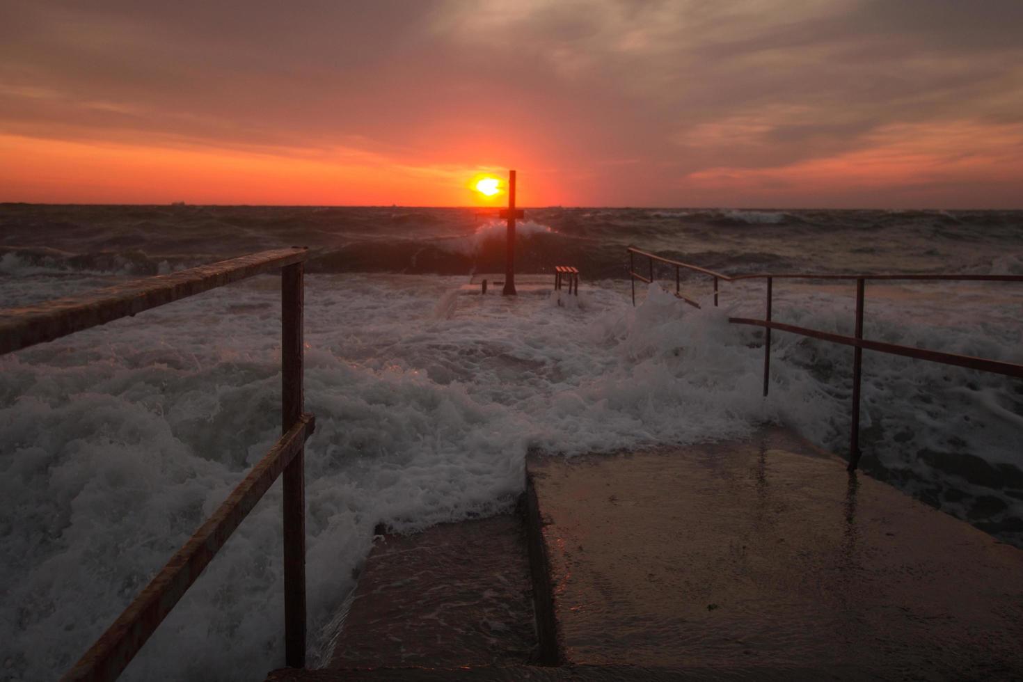 schöne meereslandschaft in der sonnenaufgangszeit, bunter rosa und orangefarbener himmel und sturm im meer. foto