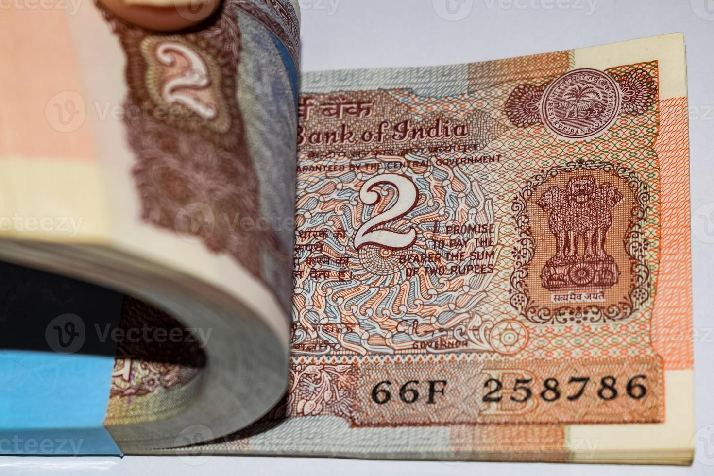 alte zwei rupie-scheine kombiniert auf dem tisch, indisches geld auf dem rotierenden tisch. alte indische Banknoten auf einem rotierenden Tisch, indische Währung auf dem Tisch foto