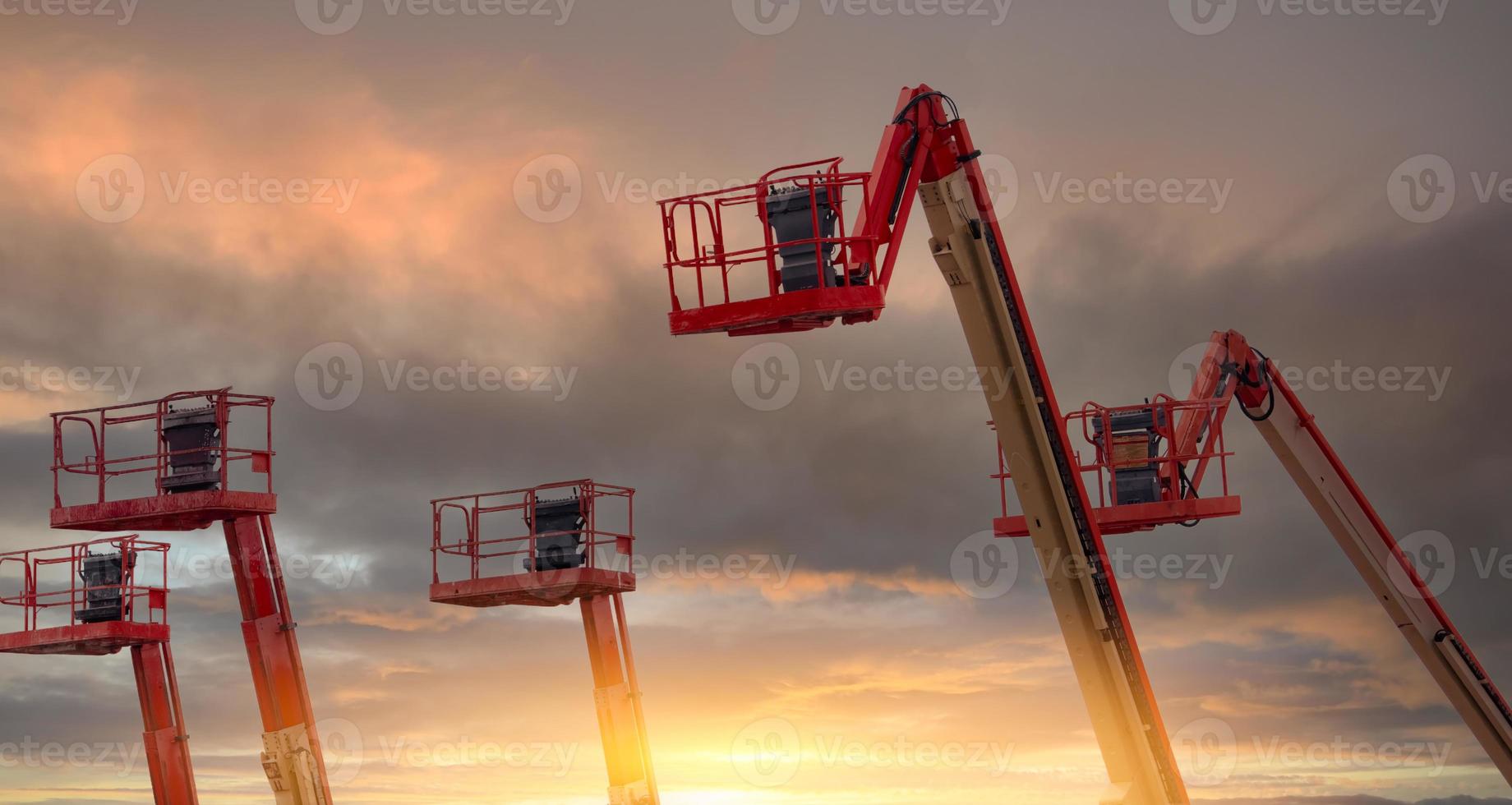 Gelenkteleskoparbeitsbühne. Hubarbeitsbühne. teleskopauslegerlift mit sonnenuntergangshimmel. Mobilbaukran zu vermieten. Reparatur von hydraulischen Auslegerhebebühnen. Kran Händler. sichere Benutzung von Maschinen. foto