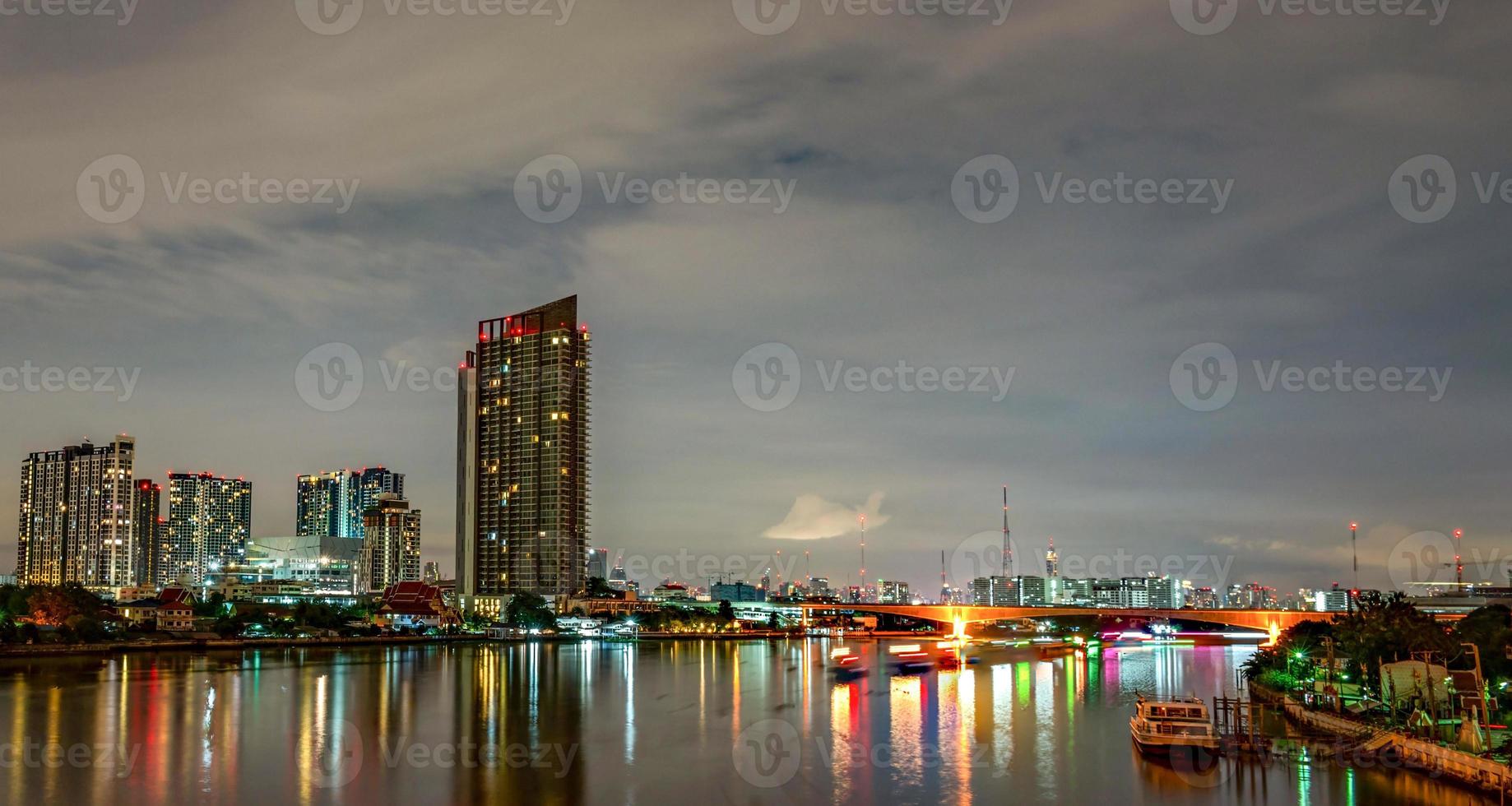 stadtbild eines modernen gebäudes nahe dem fluss in der nacht. Bürogebäude der modernen Architektur. Wolkenkratzer mit Abendhimmel. Schwarz-Weiß-Bild. Nachtfotografie des Gebäudes am Flussufer. foto