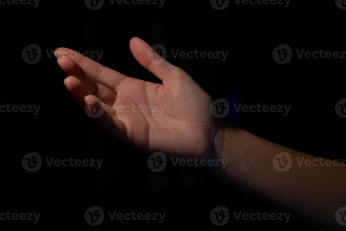 Frau Hände Handflächen nach oben auf schwarzem Hintergrund foto