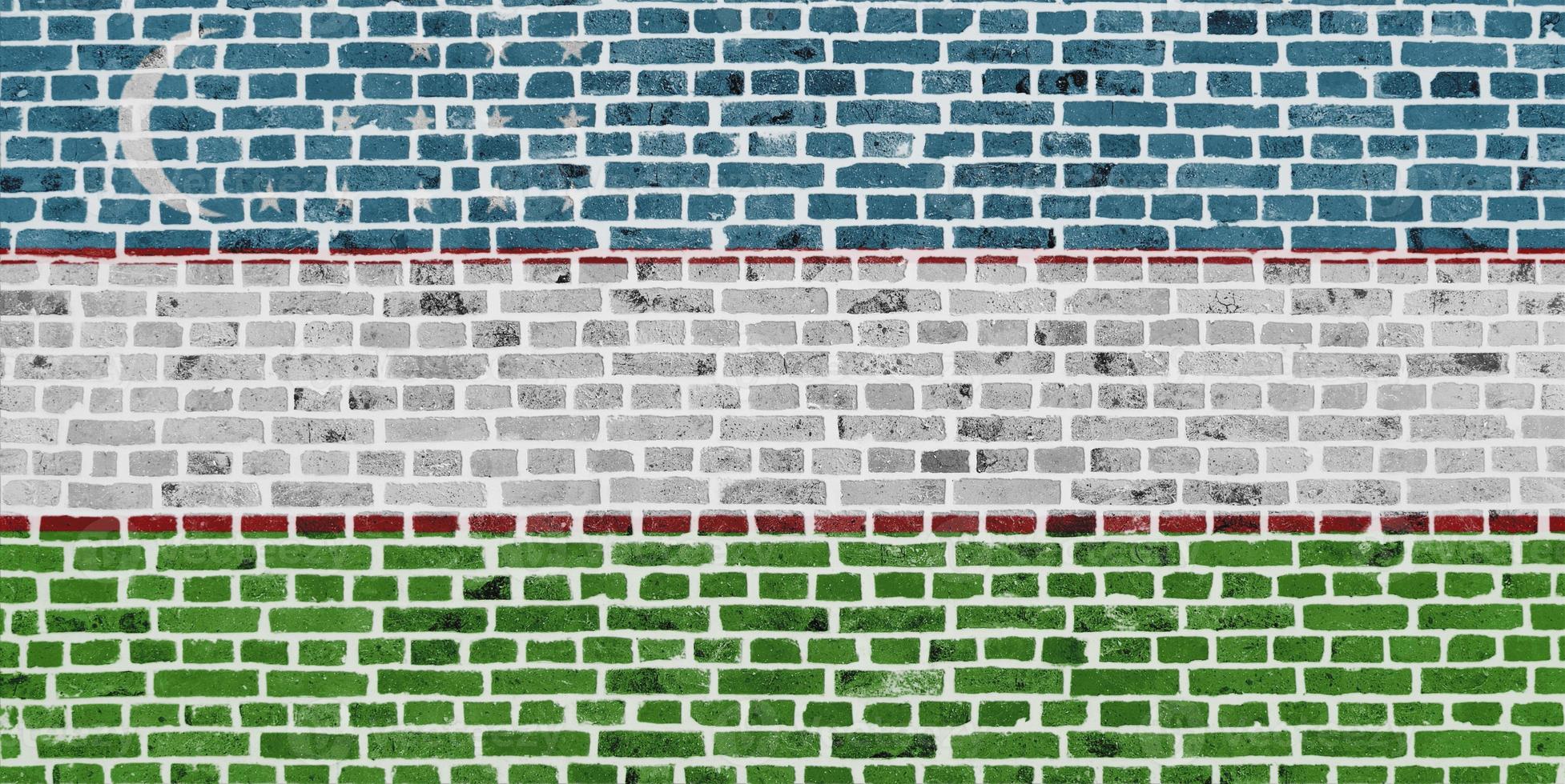 Flagge Usbekistans auf eine Mauer gemalt foto