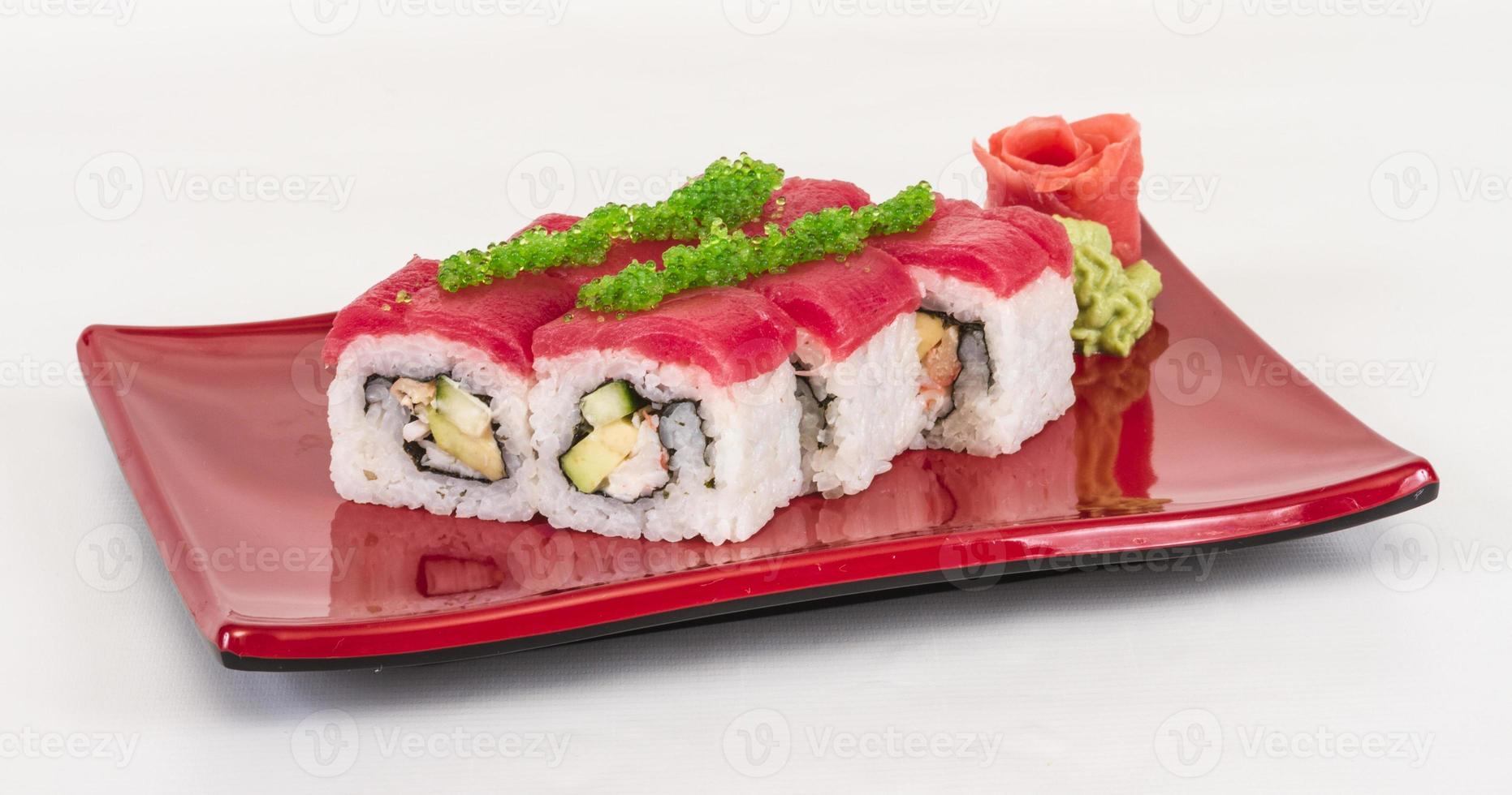 Maki-Sushi - Rolle aus Krabben, Avocado, Gurken im Inneren. frischer Thunfisch und Tobico-Rogen draußen foto