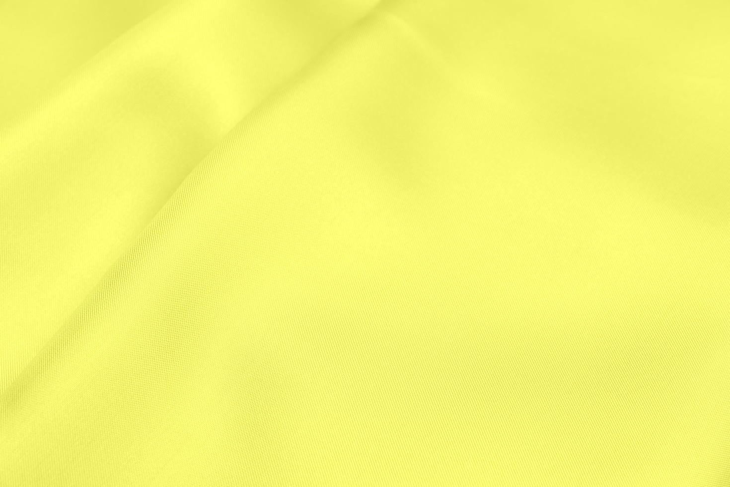 gelber Satinstoff Textur weicher Unschärfehintergrund foto