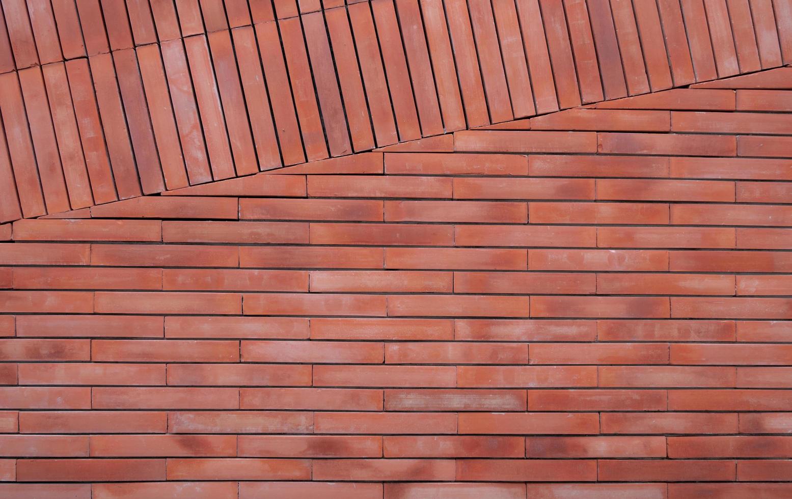 orange Mauer Textur Hintergrund. orange Vintage-Mustertapete. leere Ziegelwand. orangefarbener Brickwall-Hintergrund. Innenarchitektur der Hauswand. rote Hauswand. Ziegelstein in helloranger Farbe. foto