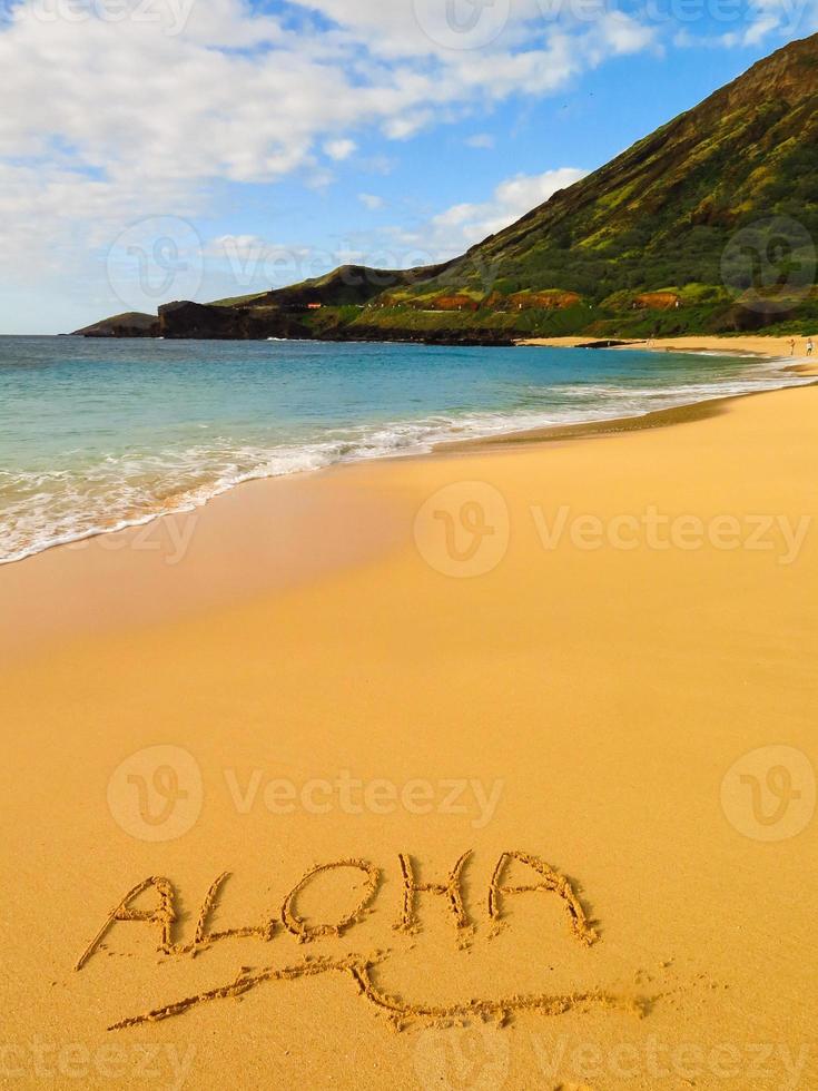 "Aloha" Nachricht im Sand am hawaiianischen Strand foto