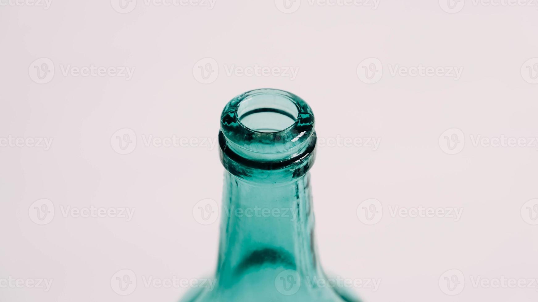 transparente grüne Glasflasche für Flüssigkeiten ohne Deckel auf weißem Hintergrund foto