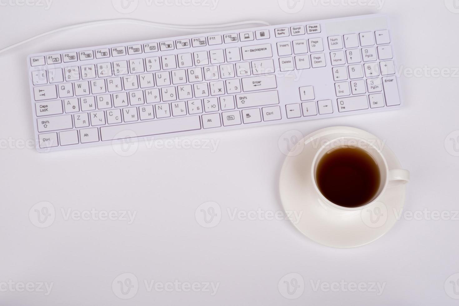 weiße Tastatur und Kaffeetasse foto
