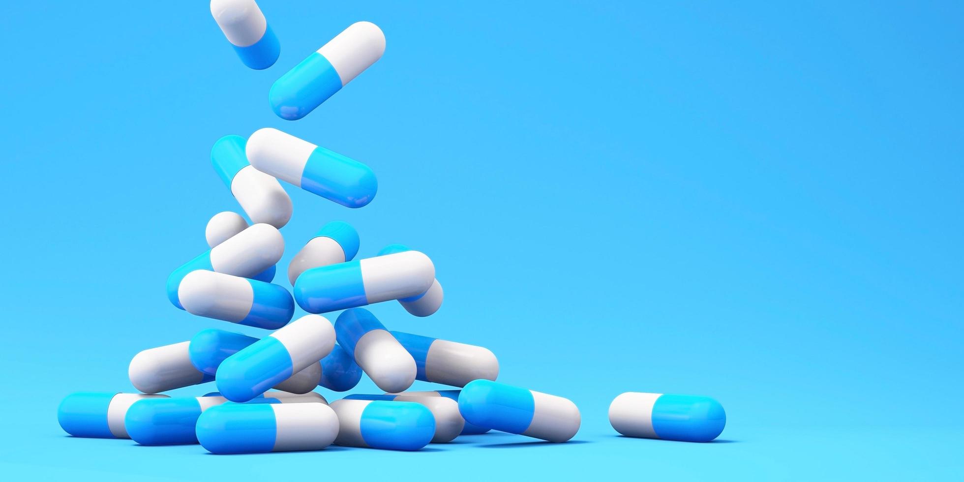 Medizinpillenkapseln, die mit blauem Hintergrund fallen., Gesundheitswesen und medizinischer 3D-Illustrationshintergrund foto