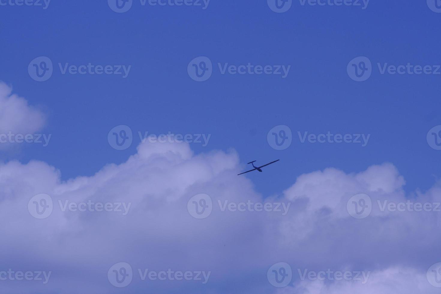 in den Wolken das ferne Flugzeug foto