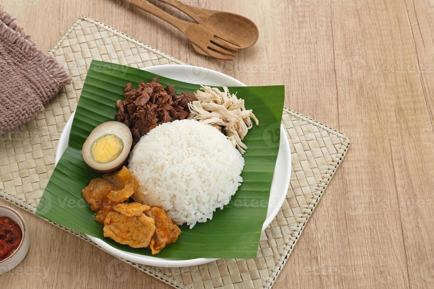 Gudeg, ein typisches Lebensmittel aus Yogyakarta, Indonesien, hergestellt aus junger Jackfrucht, gekocht mit Kokosmilch. serviert mit würzigem Eintopf aus Crackern mit Rinderhaut, braunen Eiern, zerkleinertem Hähnchen und Sambal. foto