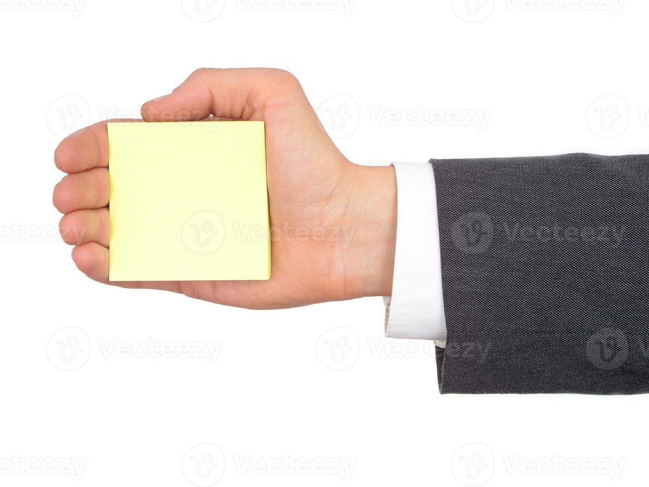 Hand des Geschäftsmannes, der gelbes Post-it hält foto