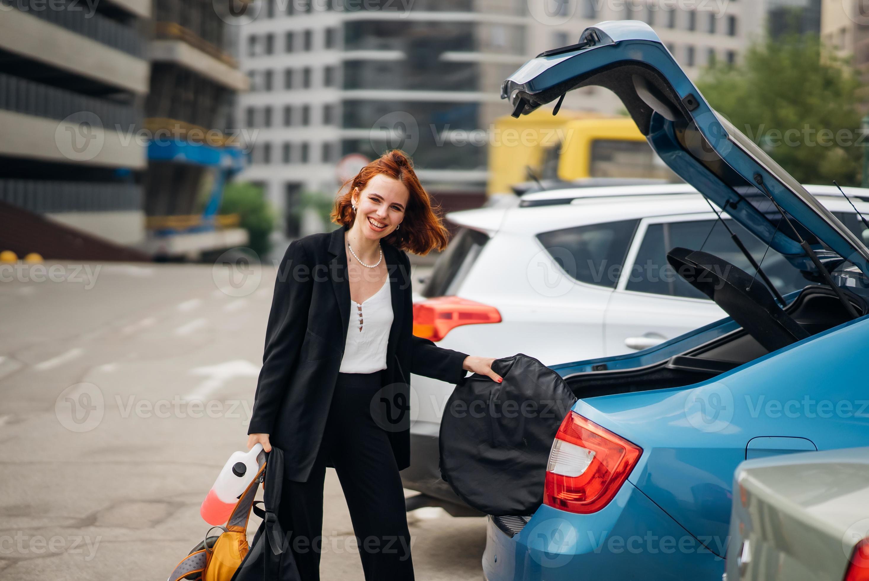 Eine Frau legt Sachen ins Auto 13632300 Stock-Photo bei Vecteezy