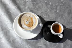 Heißer und starker Kaffee wird in eine Tasse gegossen. foto