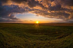 Blauer, roter Himmelshintergrund mit flauschigen, lockigen, rollenden Wolken am Abend mit untergehender Sonne. gutes windiges Wetter foto