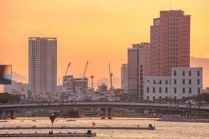 ho chi minh, vietnam - 13. feb 2022 blick auf bitexco financial tower building, gebäude, straßen, thu thiem bridge und saigon river in ho chi minh city bei sonnenuntergang. hochwertiges Panoramabild. foto