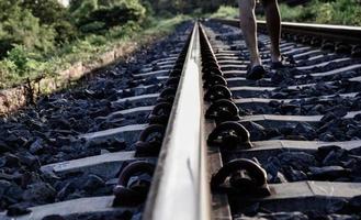 Eisenbahnschienen mit Kinderbeinen, die alleine gehen. Konzept. getrennt. soziale Probleme. Familienprobleme. lass dich nicht verlassen. beenden. foto