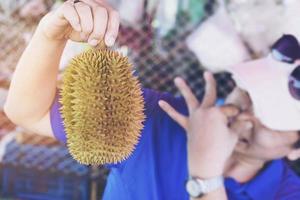 mann, der durian ekelhaften ausdruck macht foto