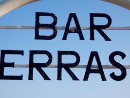 barschild, terrasse an der tür einer bar am strand foto