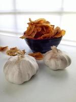 Bananenchips mit Knoblauch auf weißem Hintergrund foto