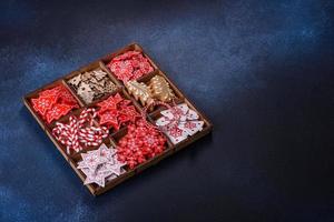 weihnachtsspielzeug in weiß und rot in einer holzbox vor dunklem betonhintergrund foto
