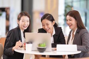 Gruppe von Geschäftsfrauen, die sich in einem Café treffen und einen Laptop verwenden. foto