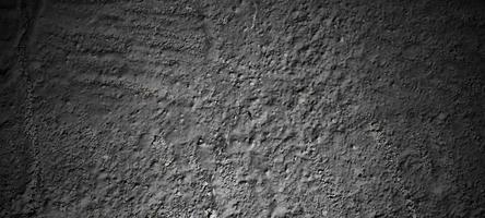 dunkelschwarzer Steinhintergrund. beängstigende schwarze Betonstruktur. Steinmauer Hintergrund. foto