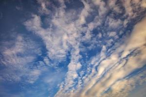 Hintergrund des blauen Himmels mit winzigen Stratus-Zirrus-gestreiften Wolken. Clearingtag und gutes windiges Wetter foto