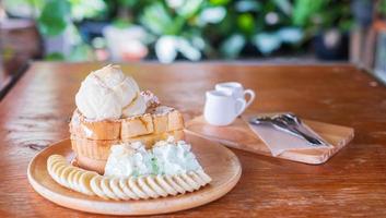 Honigtoast, Eis und Toast in einem Holztablett auf einem Holztisch. foto