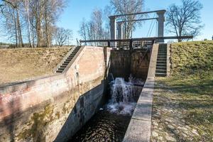 torschleuse zugbrücke bau auf fluss, kanal für vorbeifahrende schiffe bei unterschiedlichen wasserständen foto