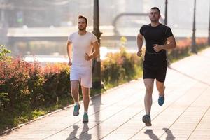 Gruppe junger Leute, die in der Stadt joggen foto